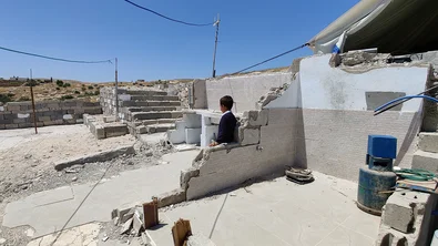 CH1548037-Lee-6-looking-at-the-rubble-after-his-home-was-demolished-in-South-Hebron-West-Bank.png