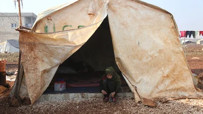 CH1641846-Hiba-12-outside-her-tent-in-the-camp-where-she-lives.JPG