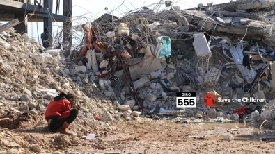CH1771207-A-girl-sits-beside-destroyed-homes-in-North-West-Syria.png