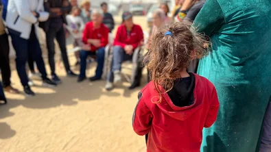 Young girl observing gathering