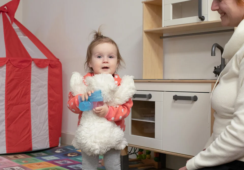 CH1667995-Kristina-14-months-plays-with-her-favourite-white-bear-in-the-child-safe-space-Poland