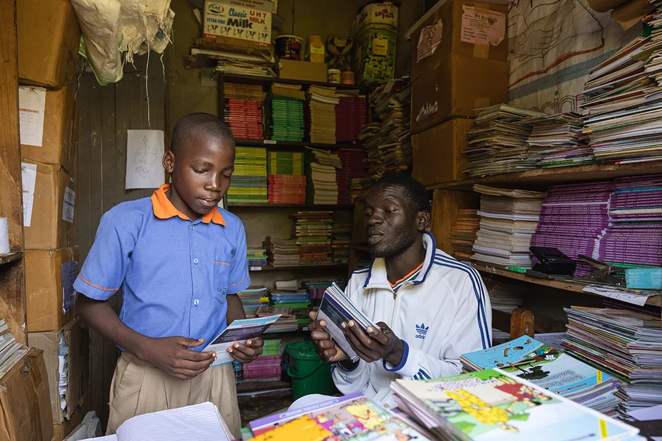 CH1745548-Timon-11-gets-a-book-from-the-school-library-room-Wakiso-Uganda.png%3Fext%3D.png.webp