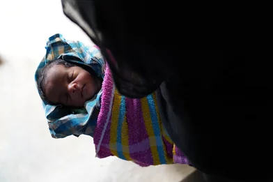 CH1820279-Newborn-baby-Sahida-being-held-by-her-grandmother-Nur-Halima-at-the-family-shelter.JPG