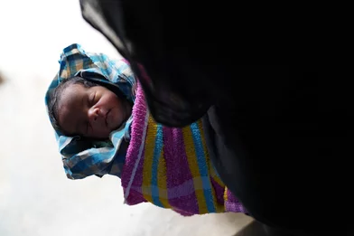 CH1820279-Newborn-baby-Sahida-being-held-by-her-grandmother-Nur-Halima-at-the-family-shelter.JPG