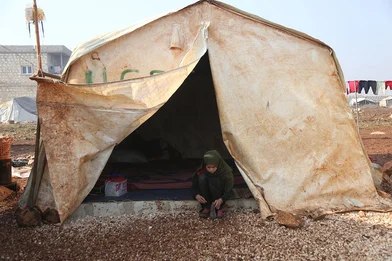 CH1641846-Hiba-12-outside-her-tent-in-the-camp-where-she-lives.JPG