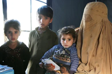 asra is at save the childrens health clinic-with her children