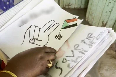 Een tekening met een peace teken en de Soedanese vlag, gemaakt door een Soedanees kind