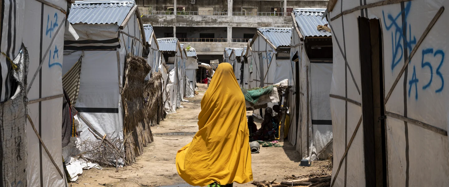 CH1727450-Miriam-16-walks-past-tents-in-a-camp-for-internally-displaced-people-in-Borno-Nigeria.jpg