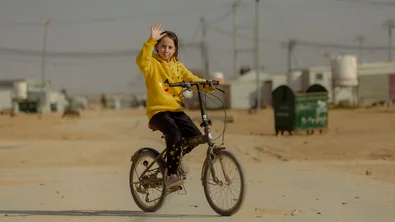 CH1796309-Jana-age-13-riding-her-bicycle-from-her-home-to-the-Coaching-for-Life-pitch.jpg