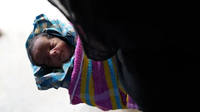 CH1820279-Newborn-baby-Sahida-being-held-by-her-grandmother-Nur-Halima-at-the-family-shelter.JPG