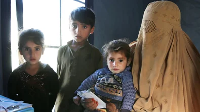 asra is at save the childrens health clinic-with her children