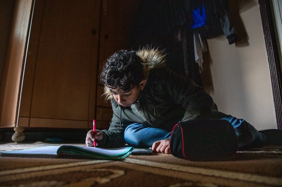 CH1689738-Adam-14-doing-his-homework-at-his-home-in-a-Palestinian-camp-in-the-south-of-Lebanon