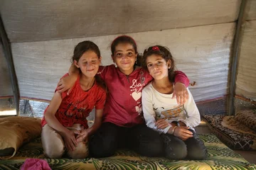 CH1732023-Hanin-11-Lujain-11-and-Lujains-nine-year-old-sister-Lina-inside-of-a-tent-in-the-displacement-camp-where-they-live-with-their-families-in-Syria